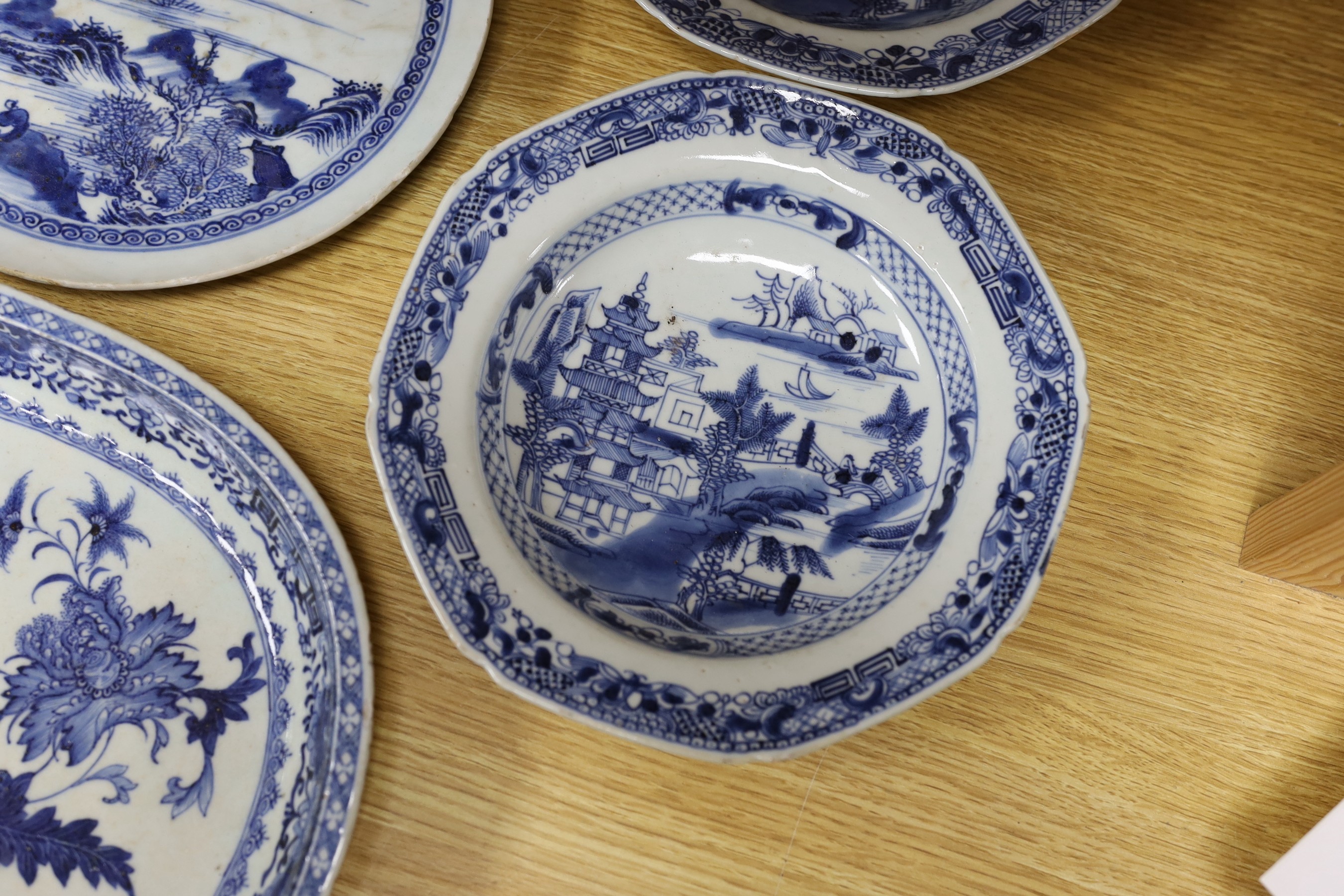 A selection of severn 18th century Chinese export blue and white dishes, largest 35cm wide